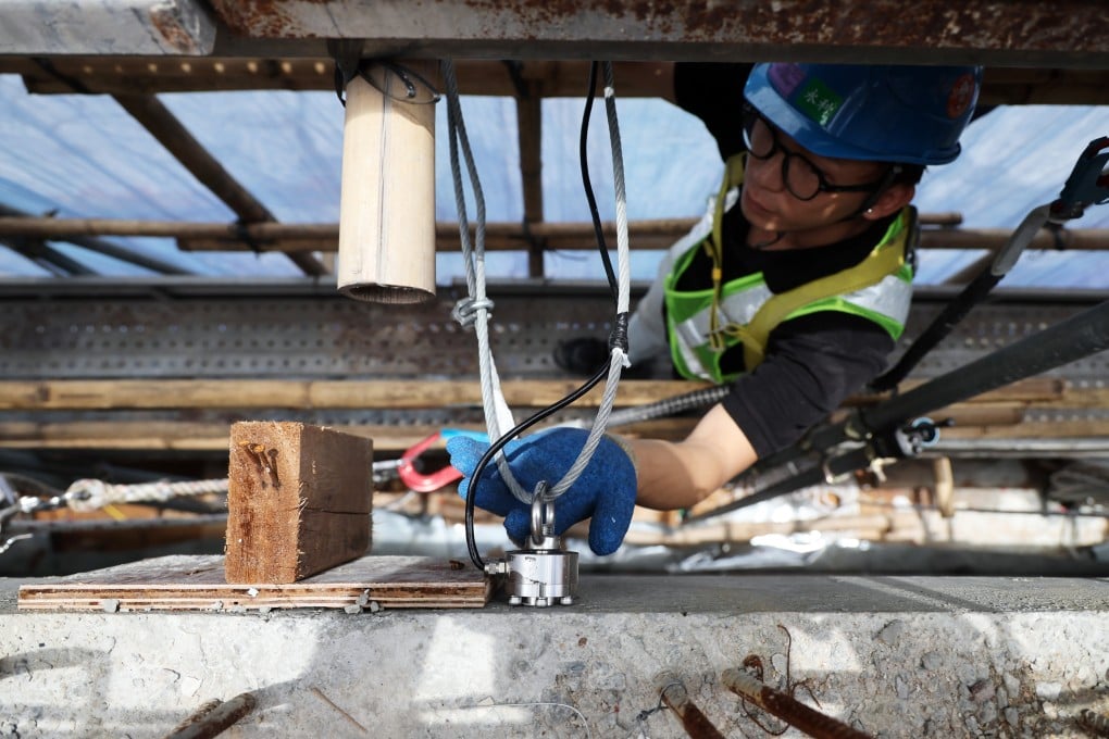 A worker demonstrates the system, which include a sensor, at a construction site in Kwu Tung. Photo: Dickson Lee