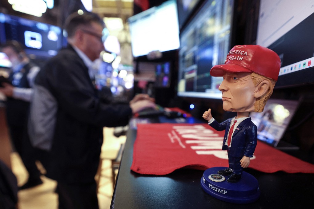 A bobble-head figurine of US President Donald Trump is seen on a desk as traders work on the floor of the New York Stock Exchange on April 14. Photo: AFP / Getty Images / TNS
