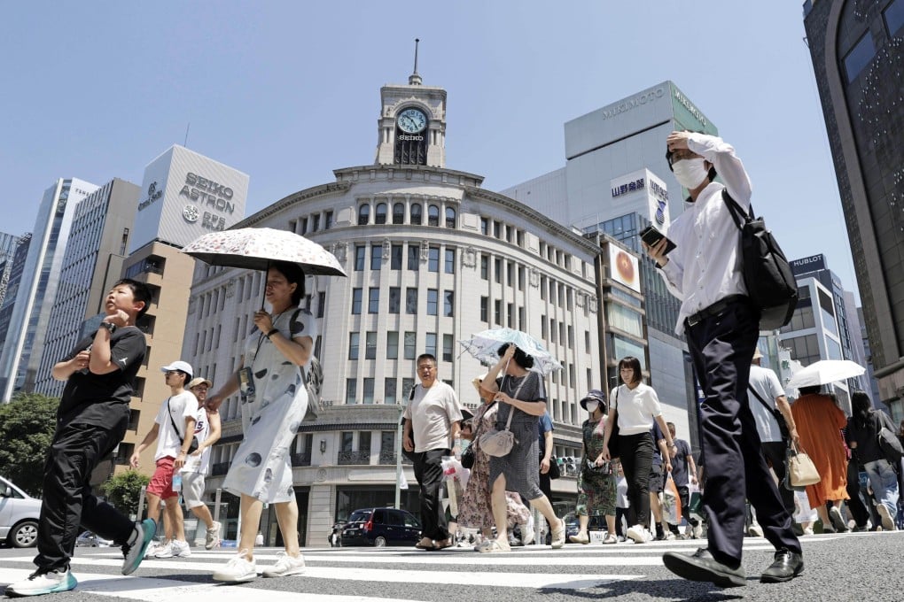 People walk amid scorching heat in Tokyo’s Ginza district on Tuesday. The Japan Meteorological Agency has warned people to take precautions against an early heatwave that has enveloped the nation. Photo: Kyodo