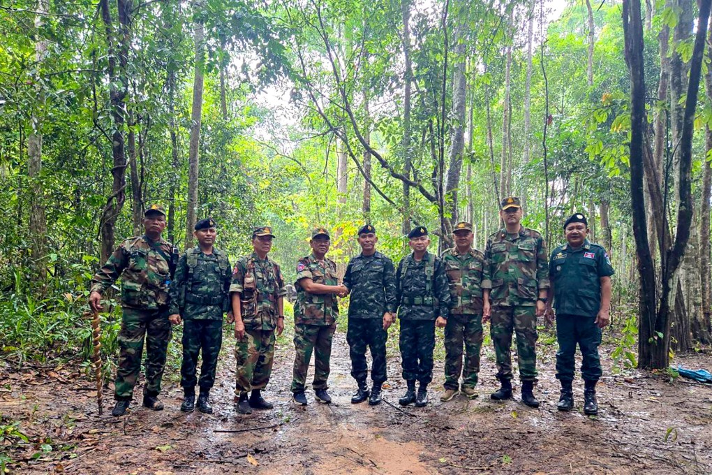 Representatives of the Royal Thai Army and the Royal Cambodian Army shake hands during military talks near the disputed border between their countries on June 8. Photo: EPA-EFE