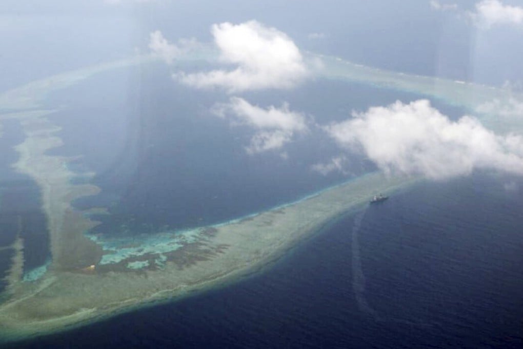 FILE - In this Aug. 31, 2018, file photo provided by the Armed Forces of the Philippines, the Philippine Navy ship BRP Gregorio del Pilar is seen at center right after it ran aground during a routine patrol, on Aug. 29, in the vicinity of Half Moon Shoal, which is called Hasa Hasa in the Philippines, off the disputed Spratlys Group of islands in the South China Sea. Philippine officials say they notified China about a navy frigate that ran aground near a hotly disputed area of the South China Sea in hopes of avoiding any misunderstandings. (Armed Forces of the Philippines via AP, File)