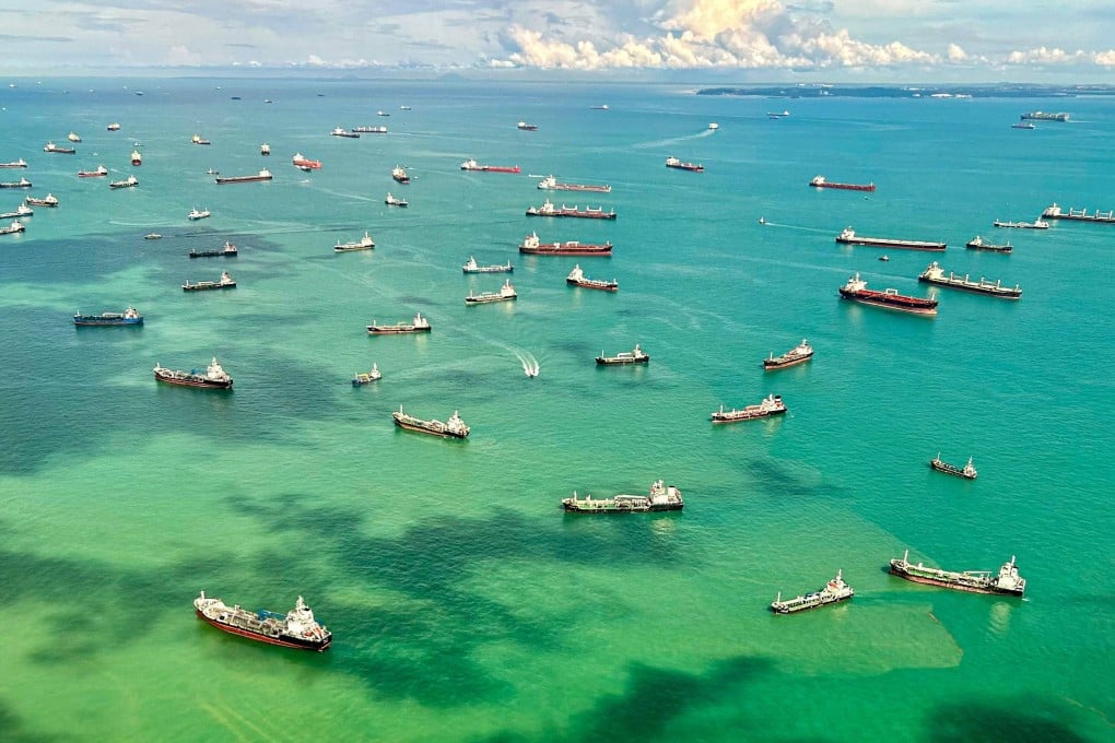 An aerial view taken from a commercial flight shows cargo ships docked along the strait in Singapore on April 7. Photo: AFP