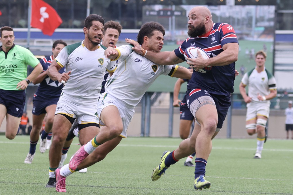 Luke van der Smit (right), pictured fending off a Brazilian tackler last November, will start for Hong Kong on Sunday. Photo: Nora Tam