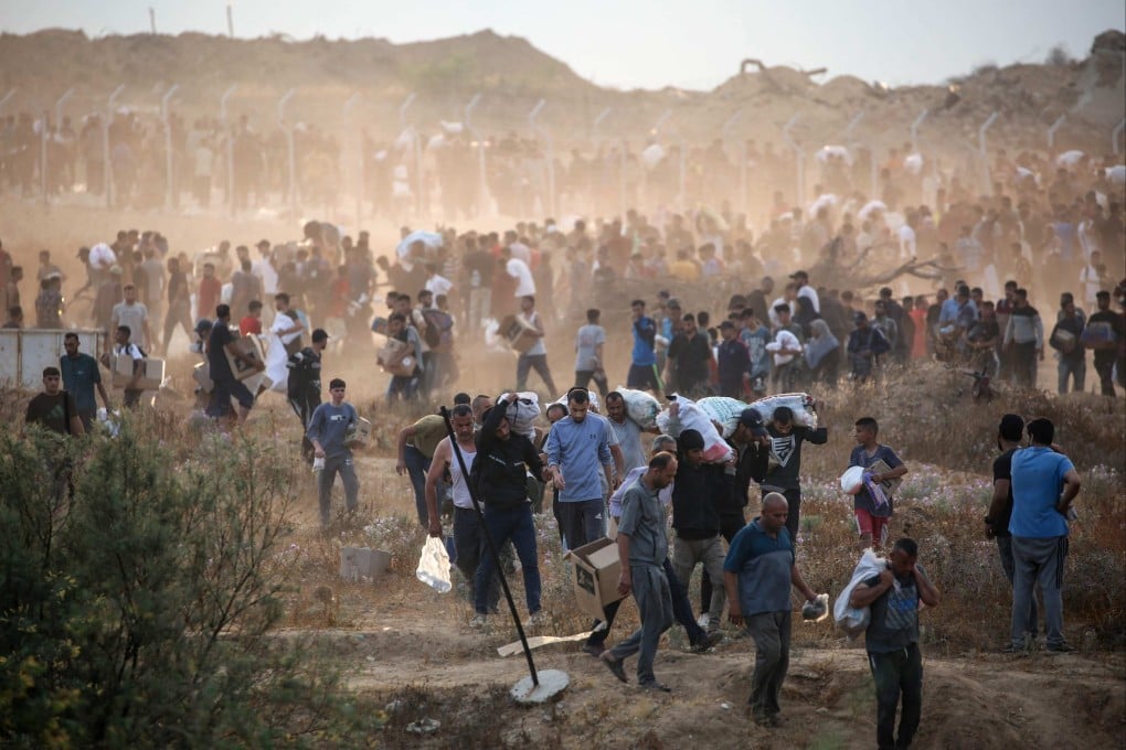People carry relief supplies from an aid distribution centre run by the Gaza Humanitarian Foundation, in the central Gaza Strip on June 8. Photo: AFP