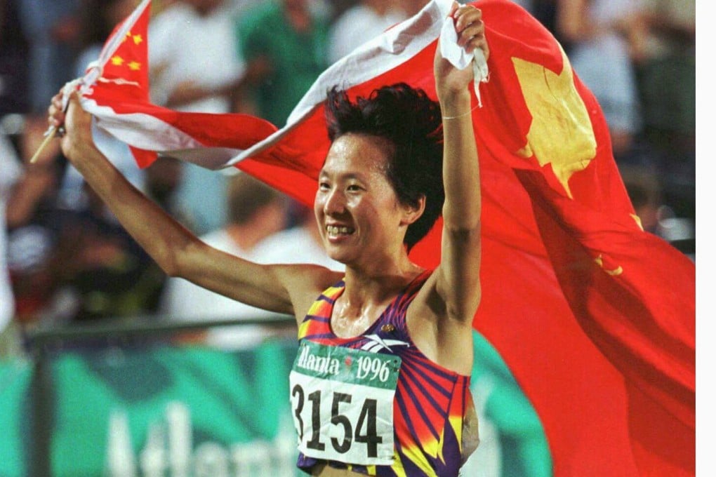 Wang Junxia of China celebrates winning gold at the 1996 Olympics in Atlanta. Photo: Reuters