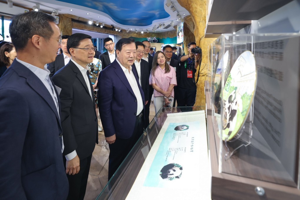 Xia Baolong (centre), with city leader John Lee and other officials, visits Ocean Park’s pandas on the third day of his trip. Photo: Handout