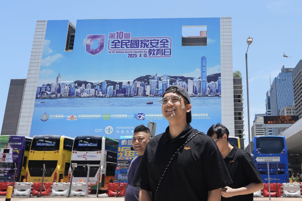 People walk past a billboard for National Security Education Day in Sheung Wan, Hong Kong, on May 12. Photo: Eugene Lee