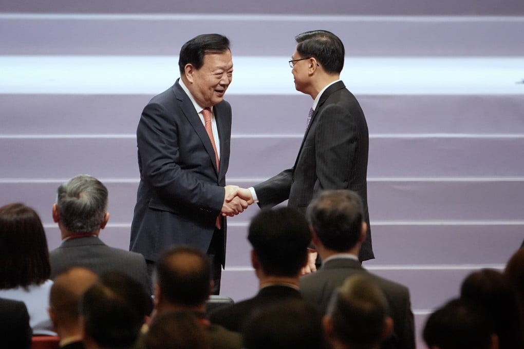 Mr Xia Baolong shakes hand with John Lee Ka-chiu in the opening ceremony of the National Security Law forum on Saturday. Photo: Elson Li
