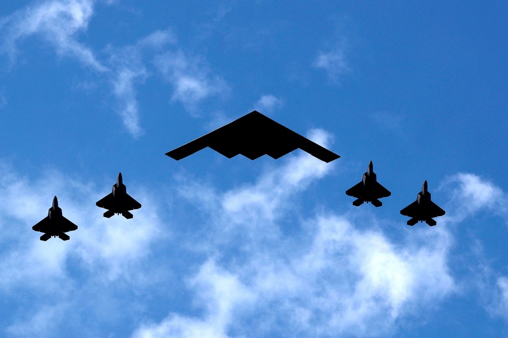 A US Air Force B-2 Spirit Stealth Bomber is flanked by four F-35 fighters during a flyover of military aircraft down the Hudson River and New York Harbour past York City, and New Jersey in July 2020. Photo: Reuters