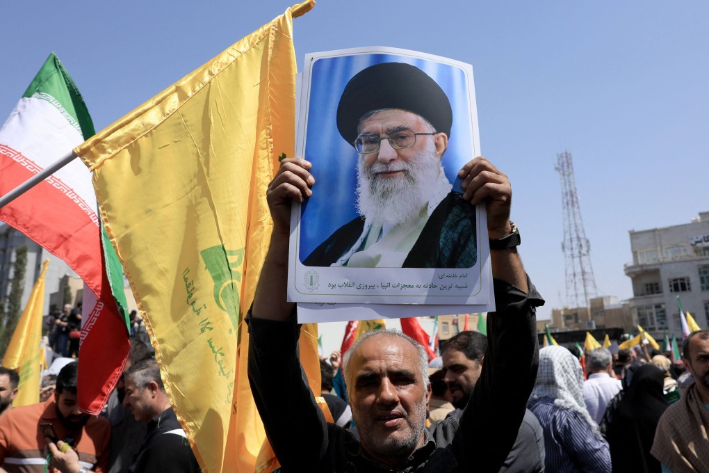 An Iranian carries a portrait of Supreme Leader Ayatollah Ali Khamenei during an anti-Israeli rally in Tehran on Friday. Photo: AFP