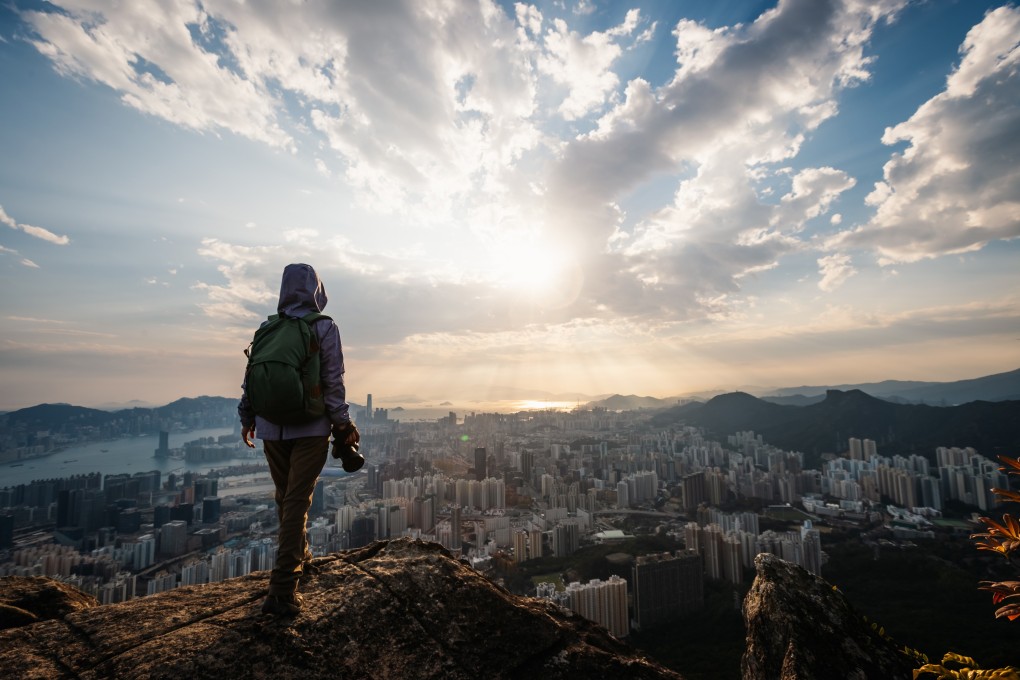 Taking photoer of Hong Kong on the monuntain cliff edge ID 2605117735 Photo: Shutterstock