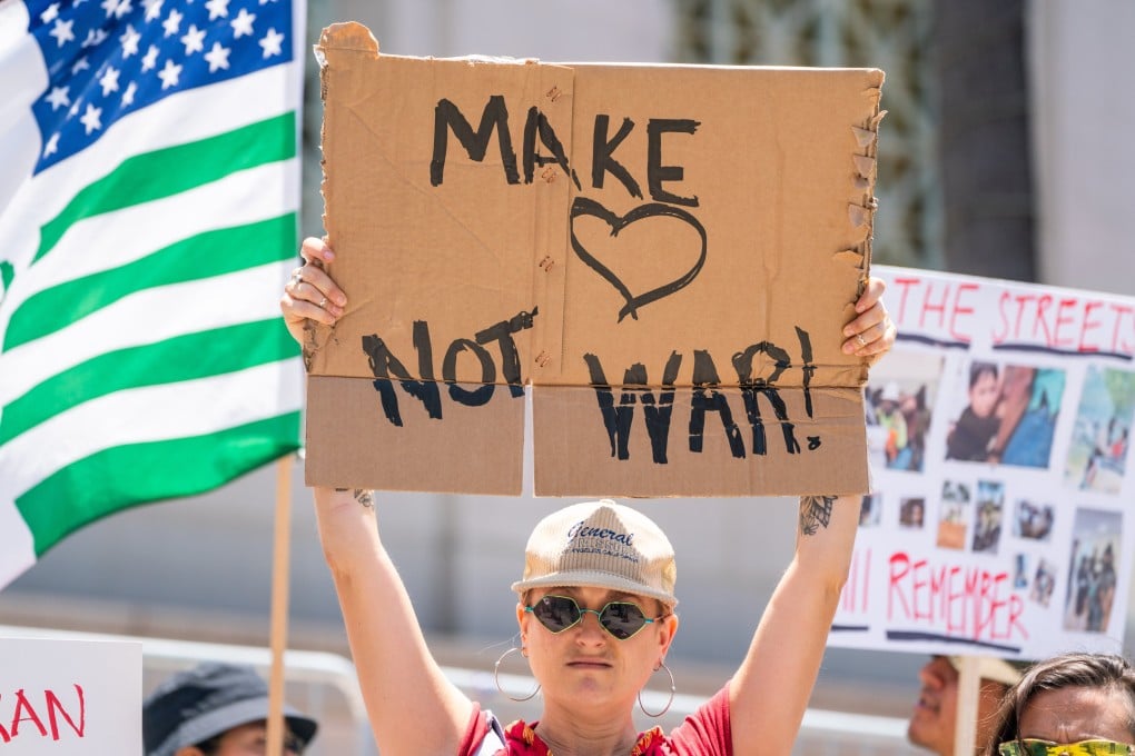 A protester in Los Angeles, California holds up a placard denouncing war following the US and Israel’s airstrikes on Iran on June 22. Photo: EPA-EFE