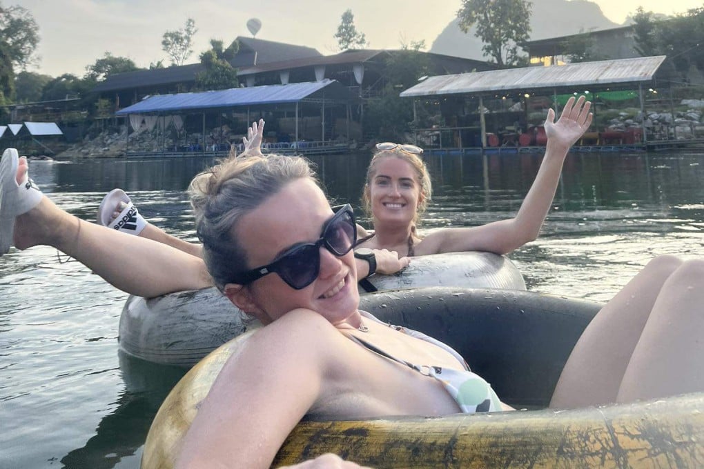 Simone White (back) and Bethany Clarke (front) tubing down a river in Laos on November 12, last year. Both would fall ill with methanol poisoning within 24 hours. Photo: Facebook/Bethany Clarke