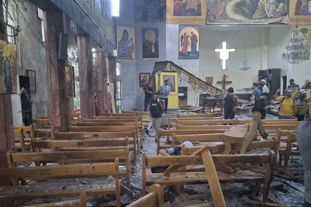 Journalists and civil defence workers inspect the damage inside Mar Elias church where a suicide bomber detonated himself in Dweil’a, on the outskirts of Damascus, Syria on Sunday. Photo: SANA via AP