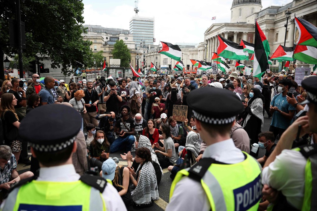 Police officers in London stand near protesters on Monday as they rally in support of pro-Palestinian group Palestine Action. Photo: AFP