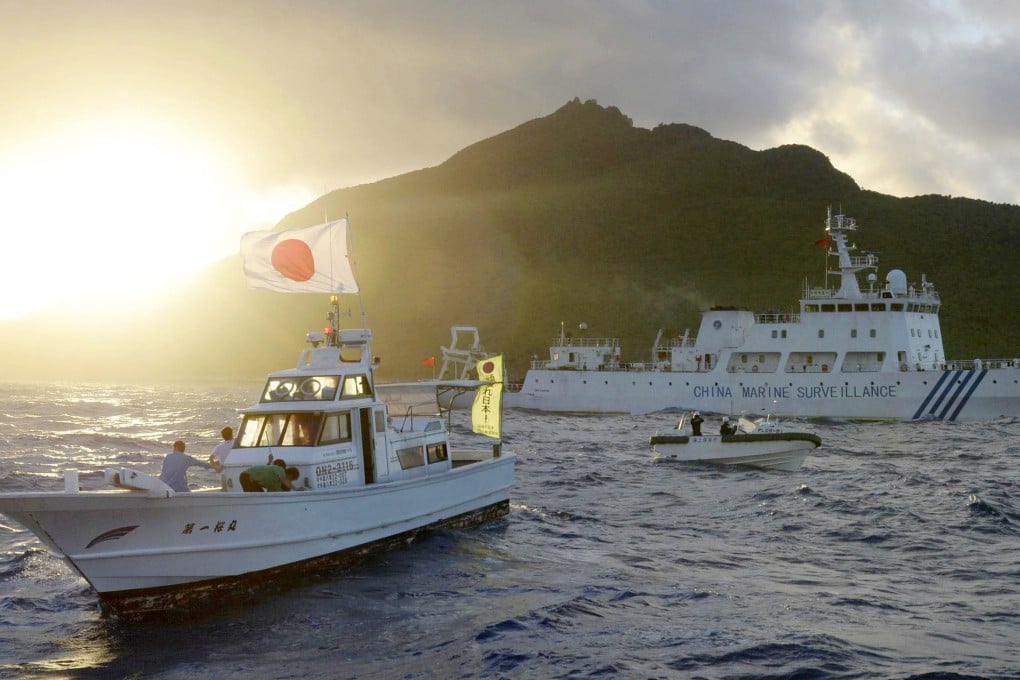 A Chinese maritime surveillance vessel and a Japanese ship pass near the Diaoyu Islands in the East China Sea. Photo: Kyodo