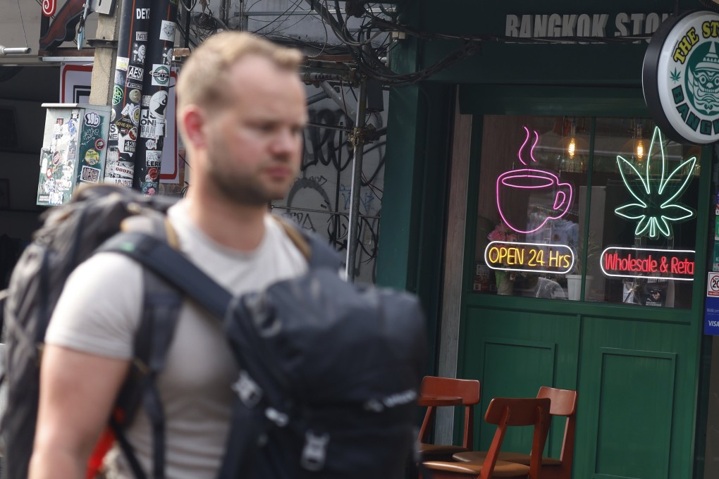 A tourist walks past a cannabis shop in the popular tourist area of Khaosan road in Bangkok. Photo: EPA-EFE
