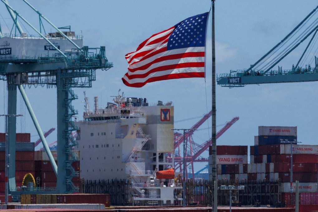 An American flag flutters over a ship and shipping containers at the Port of Los Angeles, in California. The threat of new US tariffs starting in early July is forcing companies to get goods onto vessels and to the US as quickly as possible. Photo: Reuters