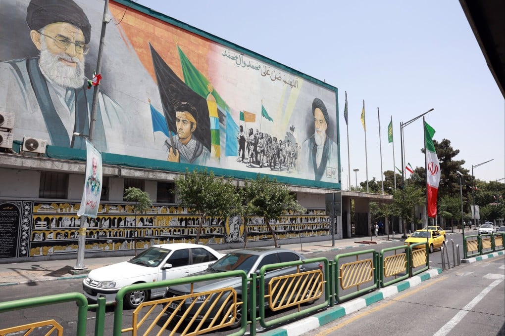 Vehicles drive past a mural showing Iran’s Supreme Leader Ayatollah Ali Khamenei (top left) and his predecessor, late supreme leader Ayatollah Ruhollah Khomeini, in Tehran on June 24. Photo: EPA-EFE