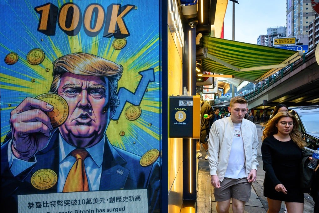 People walk past a cryptocurrency exchange office in Hong Kong with a screen showing US President Donald Trump holding cryptocurrency coins, on March 12. Photo: AFP / Getty Images / TNS