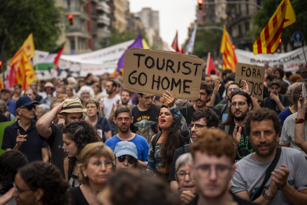 People demonstrate during a protest against overtourism in Barcelona in June 2024. The Spanish city remains at the forefront of a problem in Europe that shows little sign of ending. Photo: AP