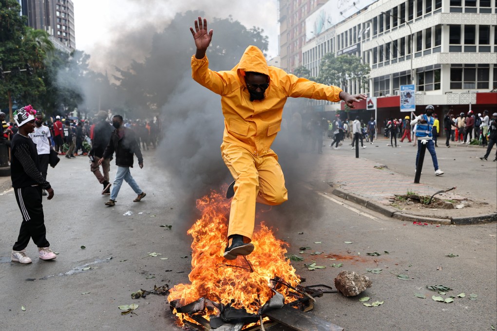 A protester jumps over a fire in the central business district of Nairobi, Kenya on Wednesday. The protest marks the first anniversary of the Gen Z protests, which culminated with the storming of the national parliament. Photo: EPA