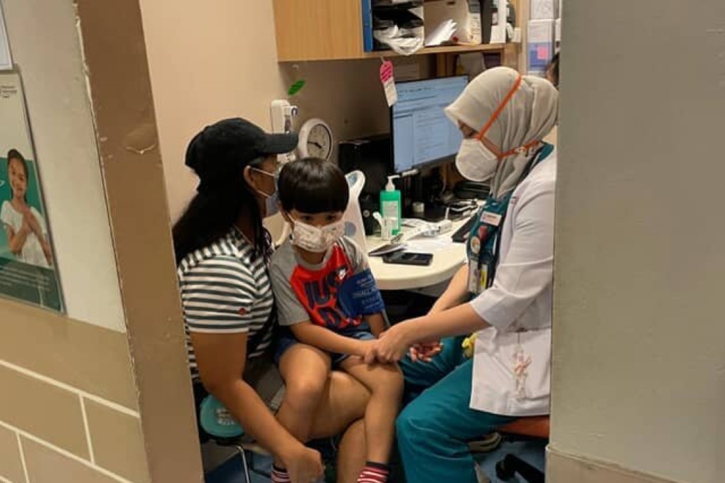 Winda’s son, 5, receiving medical attention after he was allegedly attacked with a wine bottle while he and his family were seated outside a coffee shop in Singapore’s Arab Street district on June 20. Photo: Winda