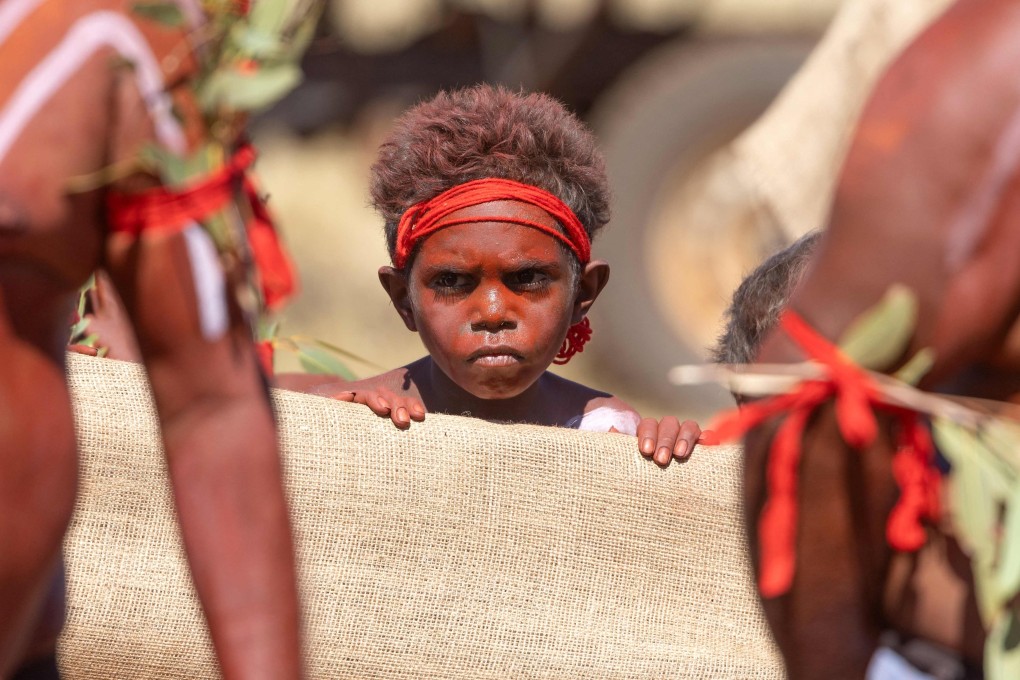 An Aboriginal child watches a dance at Ilpili in Australia’s Central Western Desert Indigenous Protected Area on March 12. Photo: AFP