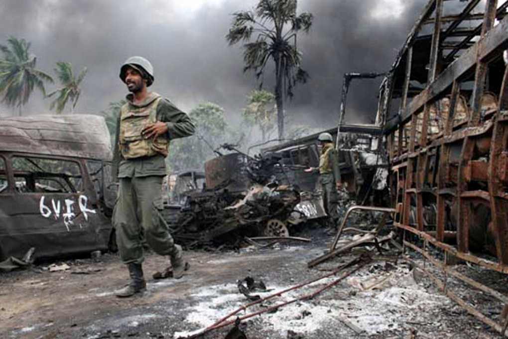 Sri Lankan troops walk among debris in a war zone during the final days of the Tamil separatist war on the Indian Ocean island in 2009. Photo: Sri Lanka Defence Ministry / AFP