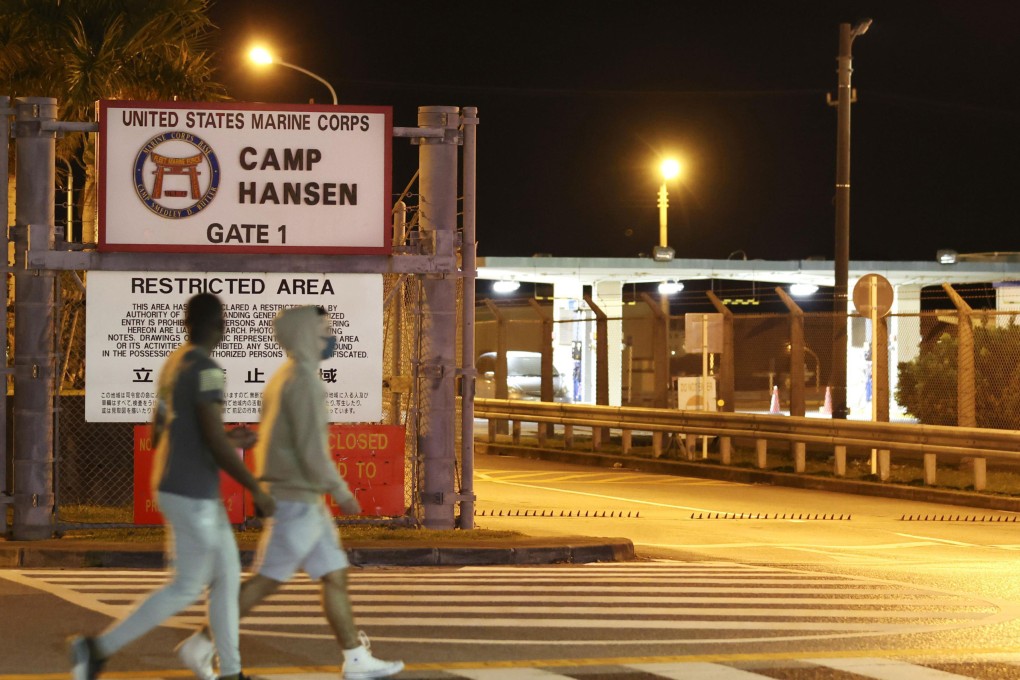 People walk past the US Marine Corps’ Camp Hansen in Japan’s Okinawa prefecture. Photo: Kyodo / AP