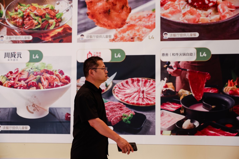 A man walks past a billboard in a shopping mall in Beijing on June 16. Photo: EPA-EFE