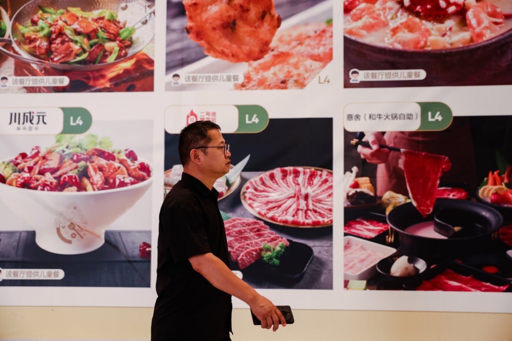 A man walks past a billboard in a shopping mall in Beijing on June 16. Photo: EPA-EFE