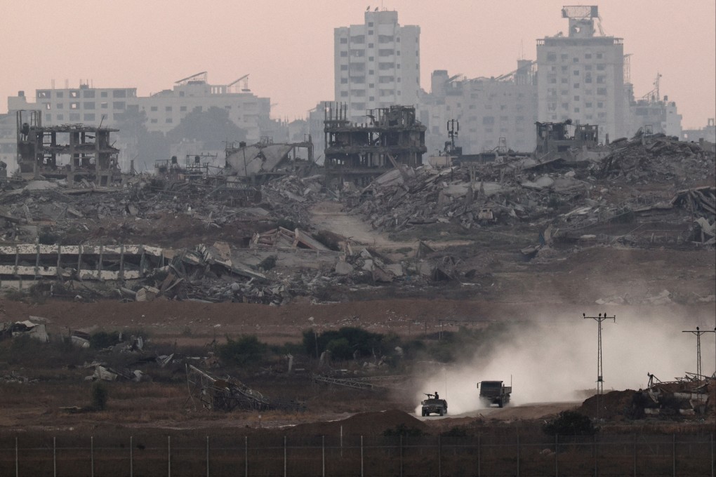 Israeli military vehicles maneuver inside the Gaza strip, as seen from Israel. Photo: Reuters