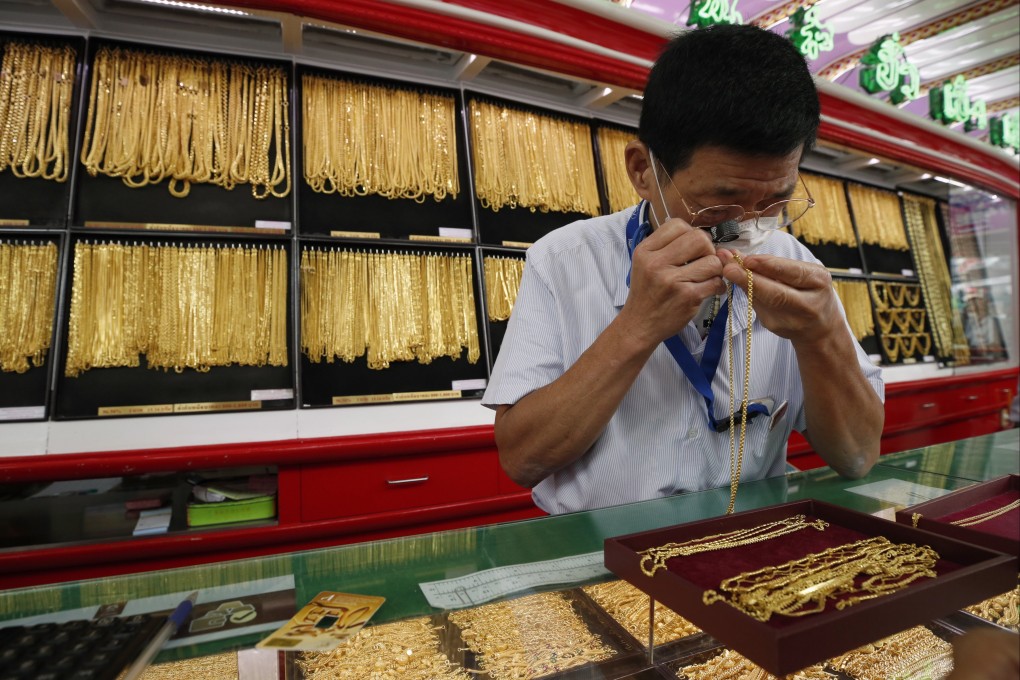 A goldsmith examines ornaments at the Hua Seng Heng gold shop in Bangkok on June 23. Thailand’s gold prices continue to surge, rising in line with the global market following US air strikes on Iran amid the Israel-Iran conflict, according to The Gold Traders Association. Photo: EPA-EFE