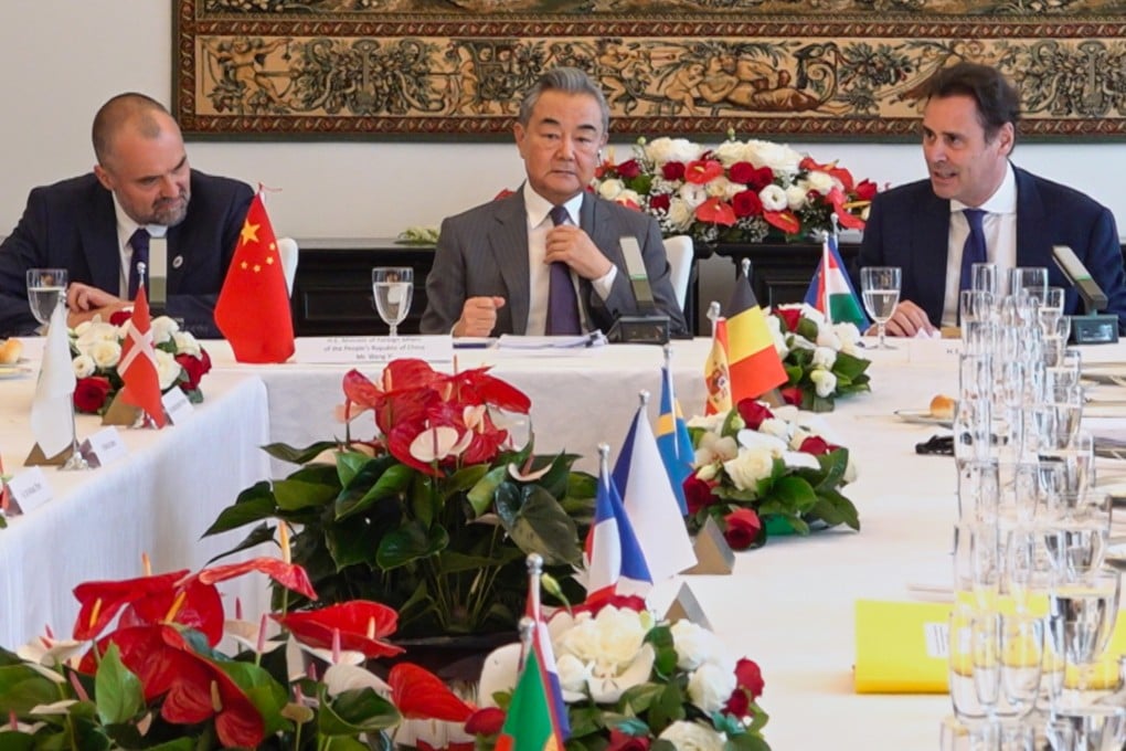 Chinese Foreign Minister Wang Yi (centre), flanked by EU ambassador Jorge Toledo (right) and Polish ambassador Jakub Kumoch, at the Polish embassy on June 25. Photo: AP