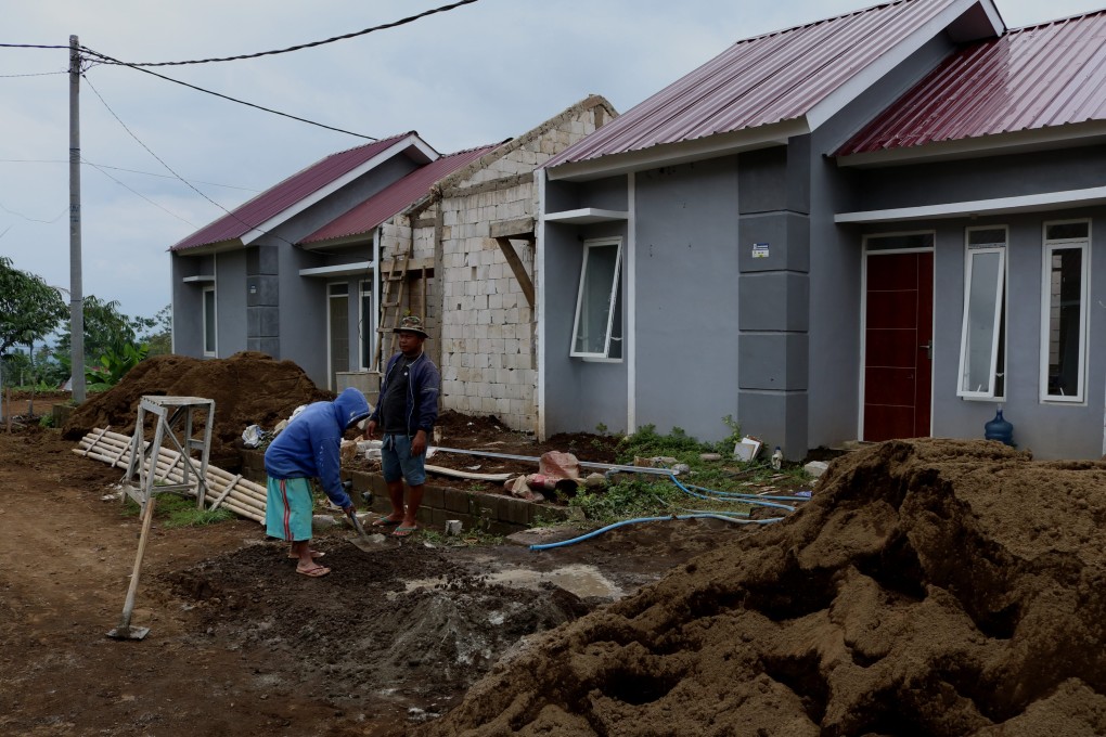 Workers build homes in a subsidised housing area in East Java, Indonesia. Photo: NurPhoto via Getty Images