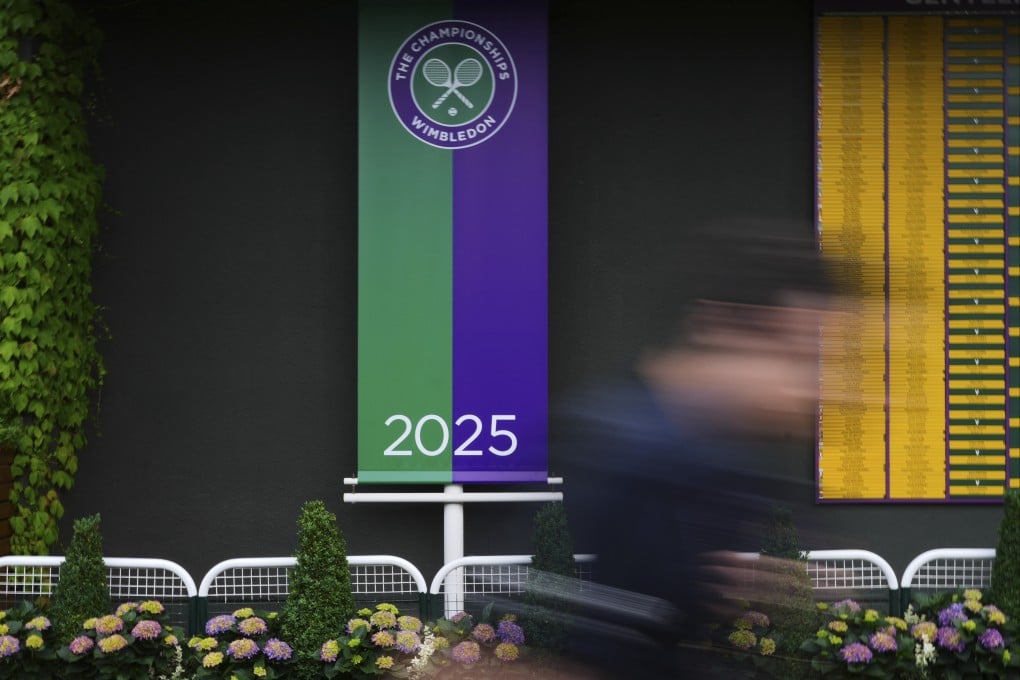 A man walks past a sign for the 2025 championships at the All England Lawn Tennis and Croquet Club, ahead of the Wimbledon Championships in London, on Wednesday. Photo: AP