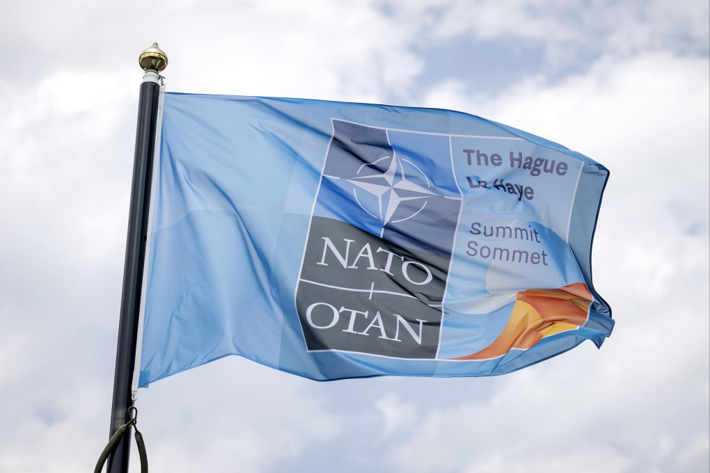 A Nato flag flutters outside the venue for an alliance summit in the Netherlands on June 22. Nato has shelved plans to open a liaison office in Tokyo. Photo: EPA-EFE