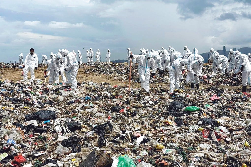 Police officers search a landfill in Tuen Mun for evidence in the case. Photo: Handout