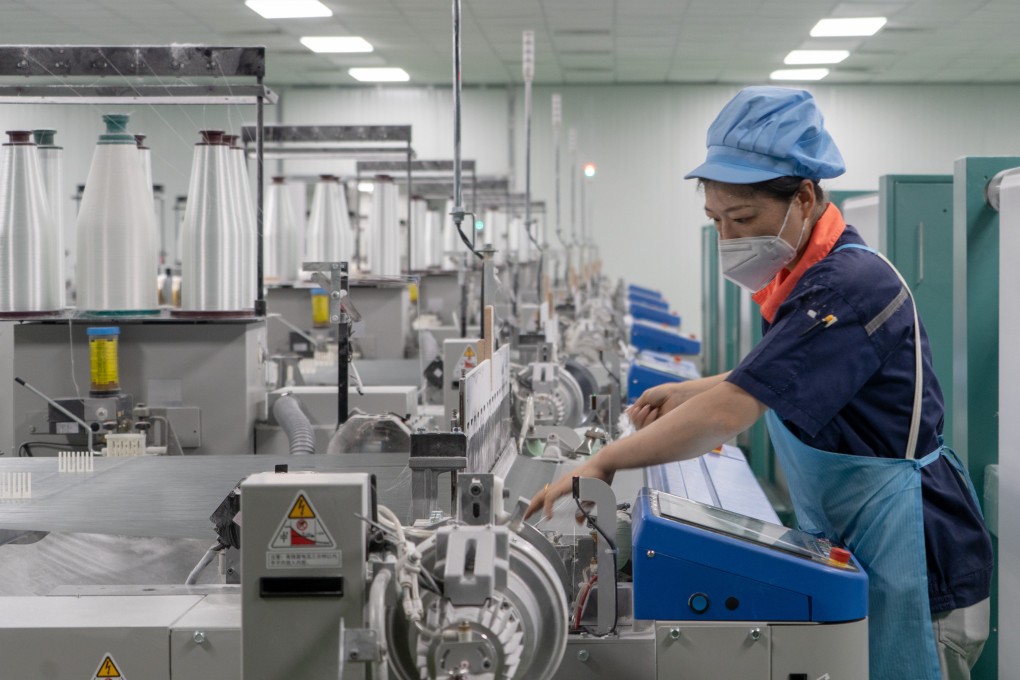 A worker handles machinery at a new-materials company in China’s Jiangxi province earlier this month. Many industrial companies saw their profits take a hit in May, according to official figures released on Friday. Photo: Xinhua