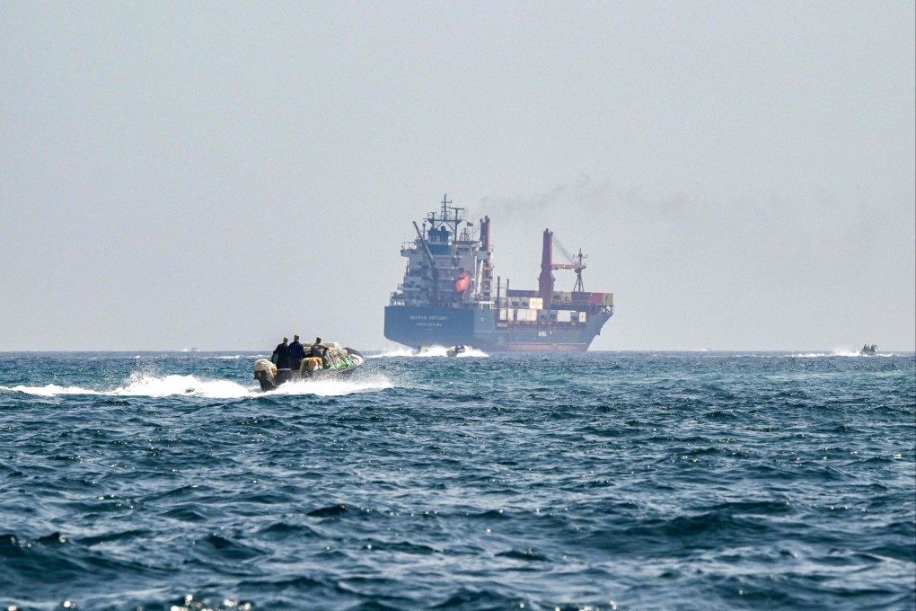 A boat approaches a container ship in the waters of the Strait of Hormuz. Photo: AFP
