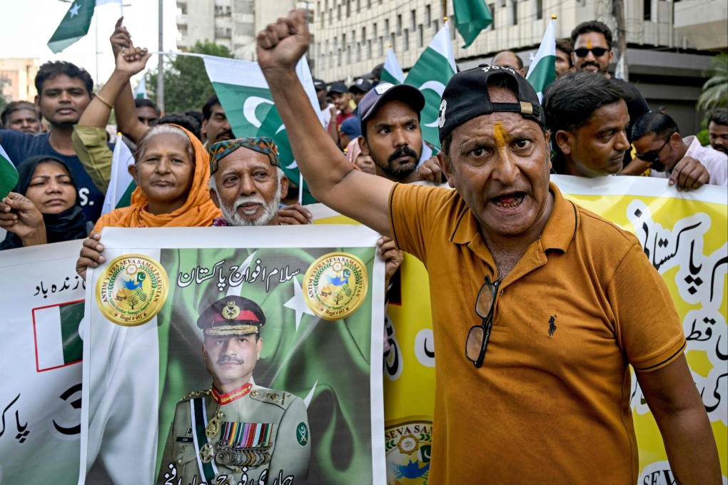Anti-India demonstrators hold a banner with a portrait of Pakistan’s army chief Asim Munir in Karachi on May 10. Photo: AFP