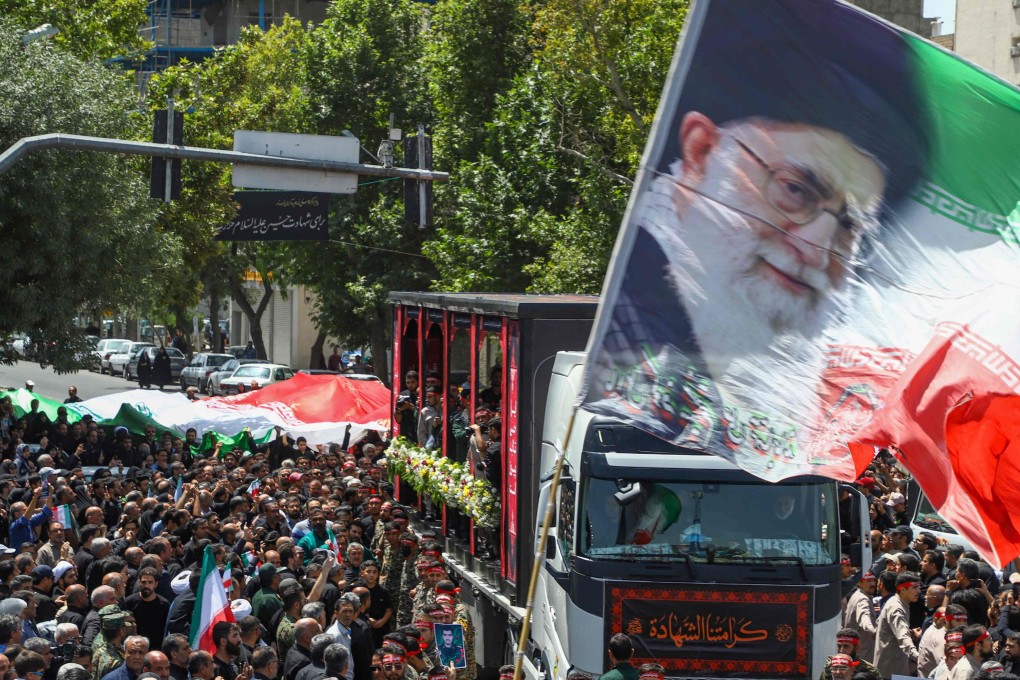 A flag with the portrait of Iran’s Supreme Leader Ayatollah Ali Khamenei is waved during Friday’s funeral procession of 15 people killed in Israeli strikes. Photo: ISNA/AFP
