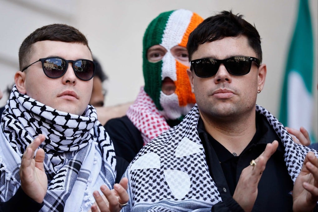 Irish rap group Kneecap singer, Liam O’Hanna (left), who performs under the stage name Mo Chara, Naoise O Caireallain, aka Moglai Bap (right) and JJ O’Dochartaigh aka DJ Provai (centre), outside Westminster Magistrates’ Court in London on June 18 after O’Hanna was released on bail until his next hearing in August. Photo: AFP