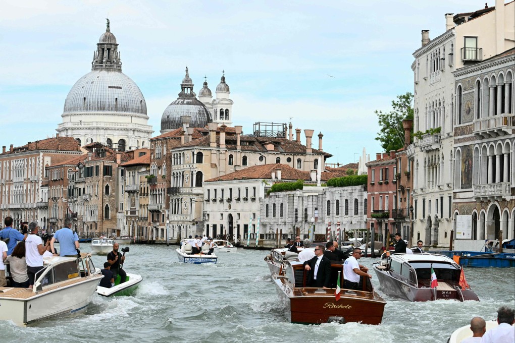 A boat transporting Amazon founder Jeff Bezos is escorted on the Grand Canal in Venice on Friday. Photo: AFP