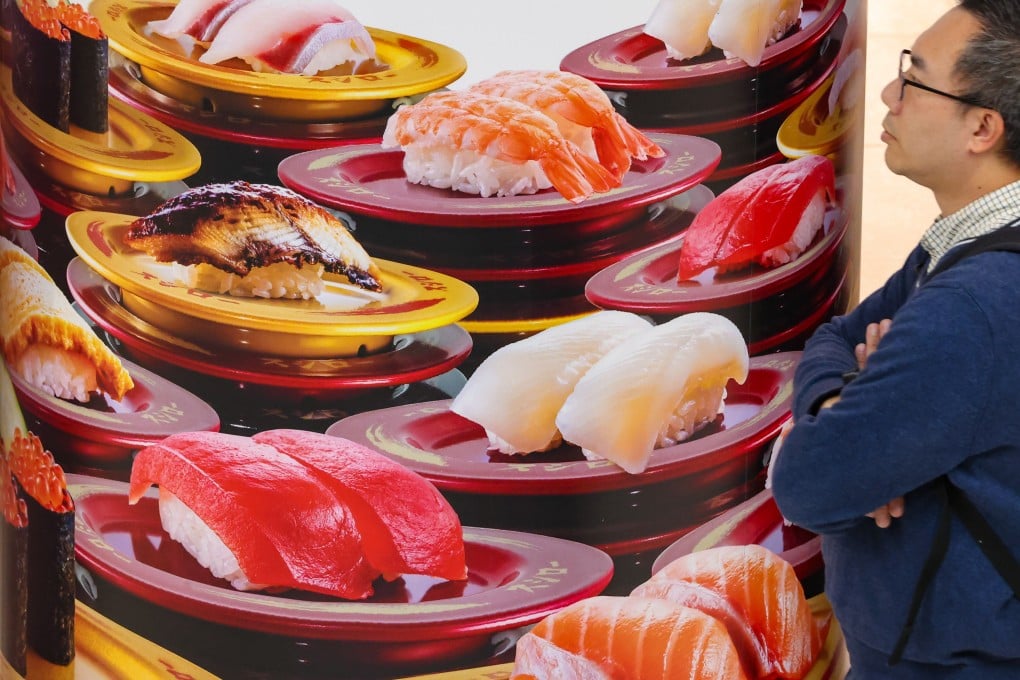A customer looks at an advertisement of a Japanese restaurant in a Mong Kok shopping centre. Photo: Jelly Tse