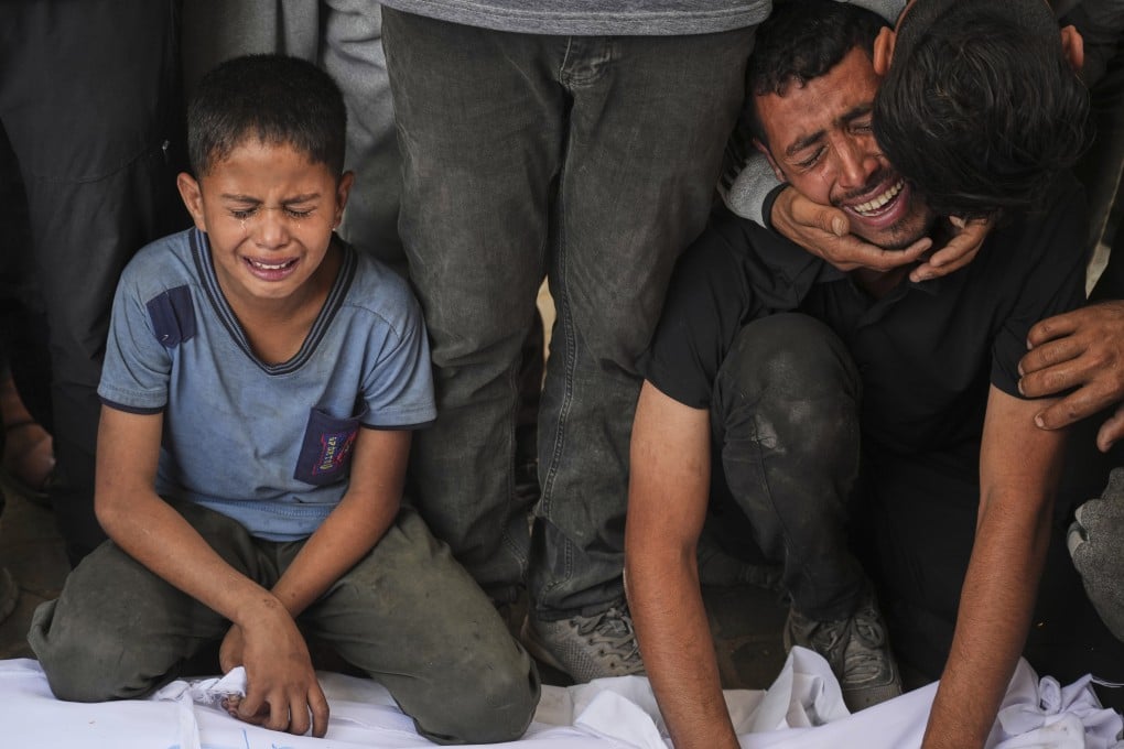 Relatives mourn over the body of a loved one killed, along with others, in Israeli strikes in the Gaza Strip. Photo: AP