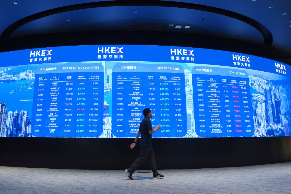 A man walks past an electronic display board at the Hong Kong stock exchange. Photo:  Xinhua
