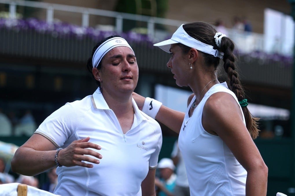Bulgaria’s Viktoriya Tomova (right) consoles Tunisia’s Ons Jabeur, who was forced to retire hurt from their first-round match at Wimbledon on Monday. Photo: Reuters