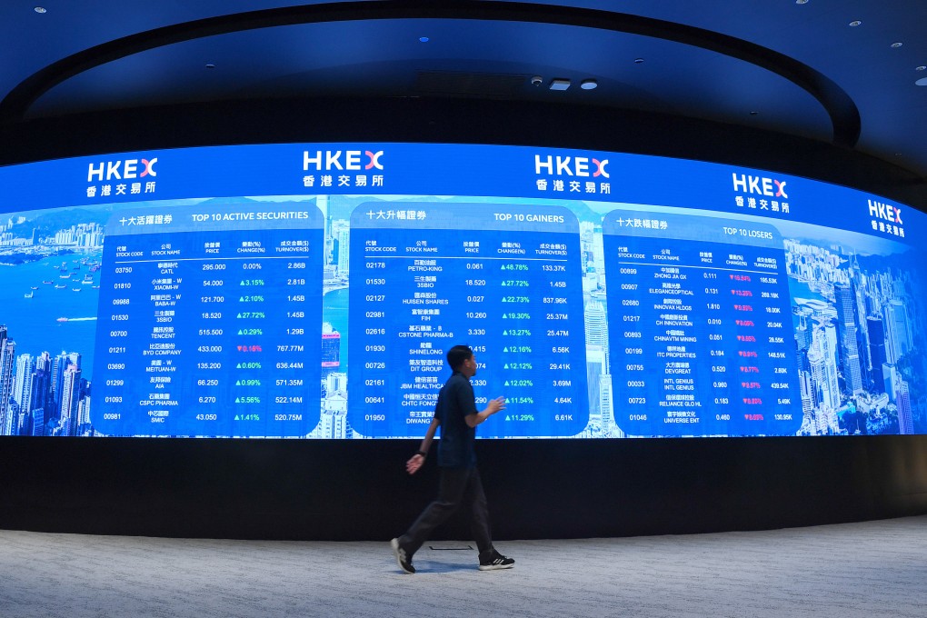 A man passes an electronic display at Hong Kong’s stock exchange. Photo: Xinhua
